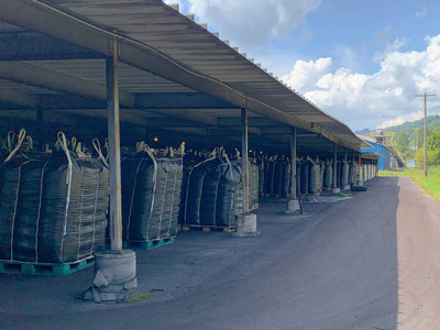 Bulk storage bags neatly arranged under a shed