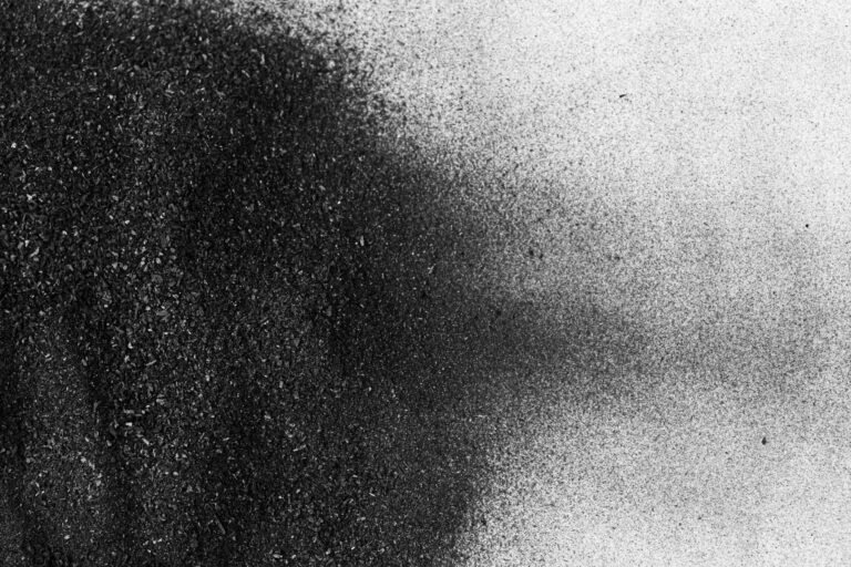 Charcoal dust texture spread on a white surface