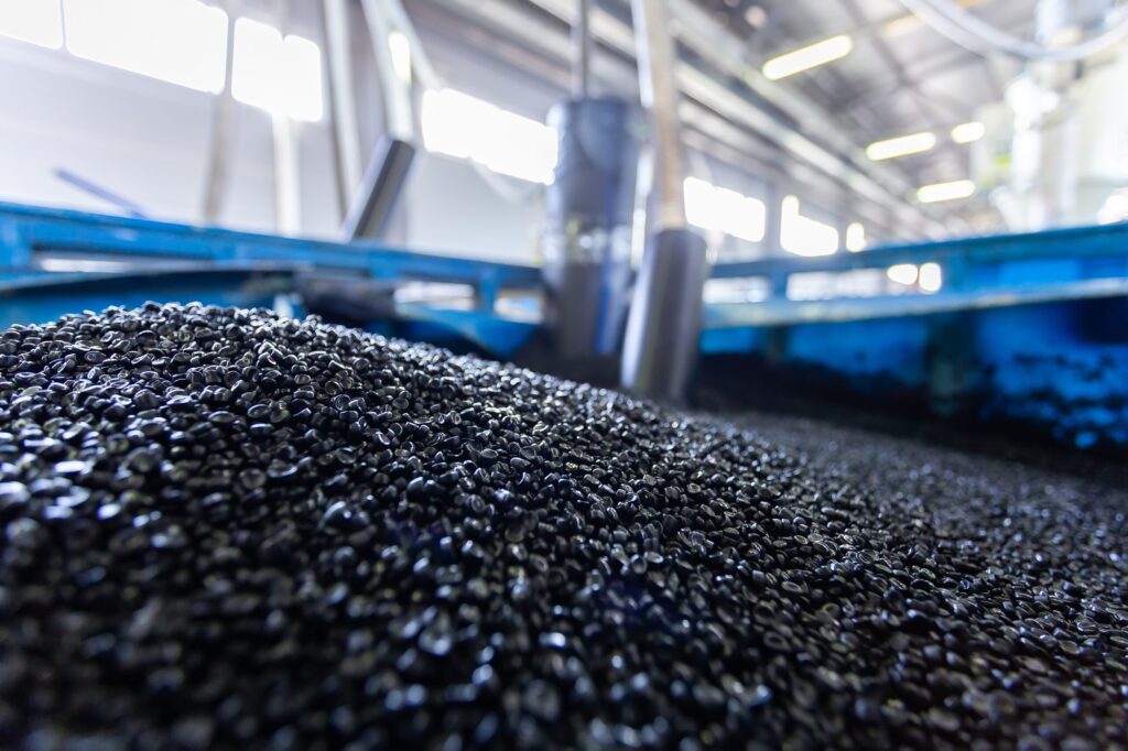 Industrial black pellets during the manufacturing process in a factory setting