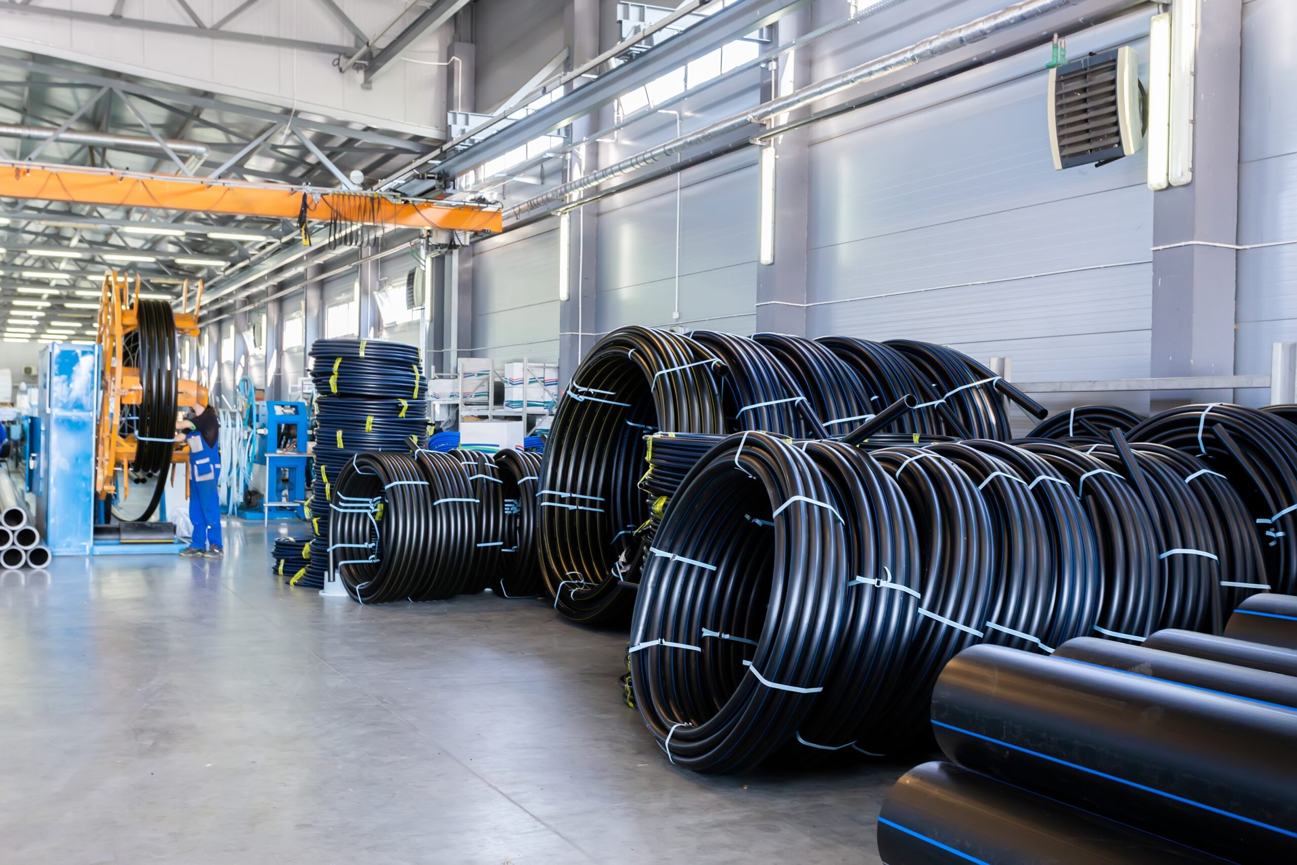 Production of industrial plastic pipes in a manufacturing facility